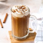 a pumpkin iced latte with whipped cream and cinnamon topping