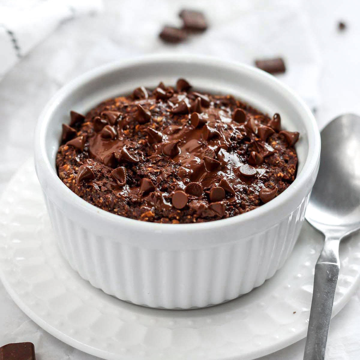 a ramekin of chocolate baked oats with chocolate chips on top