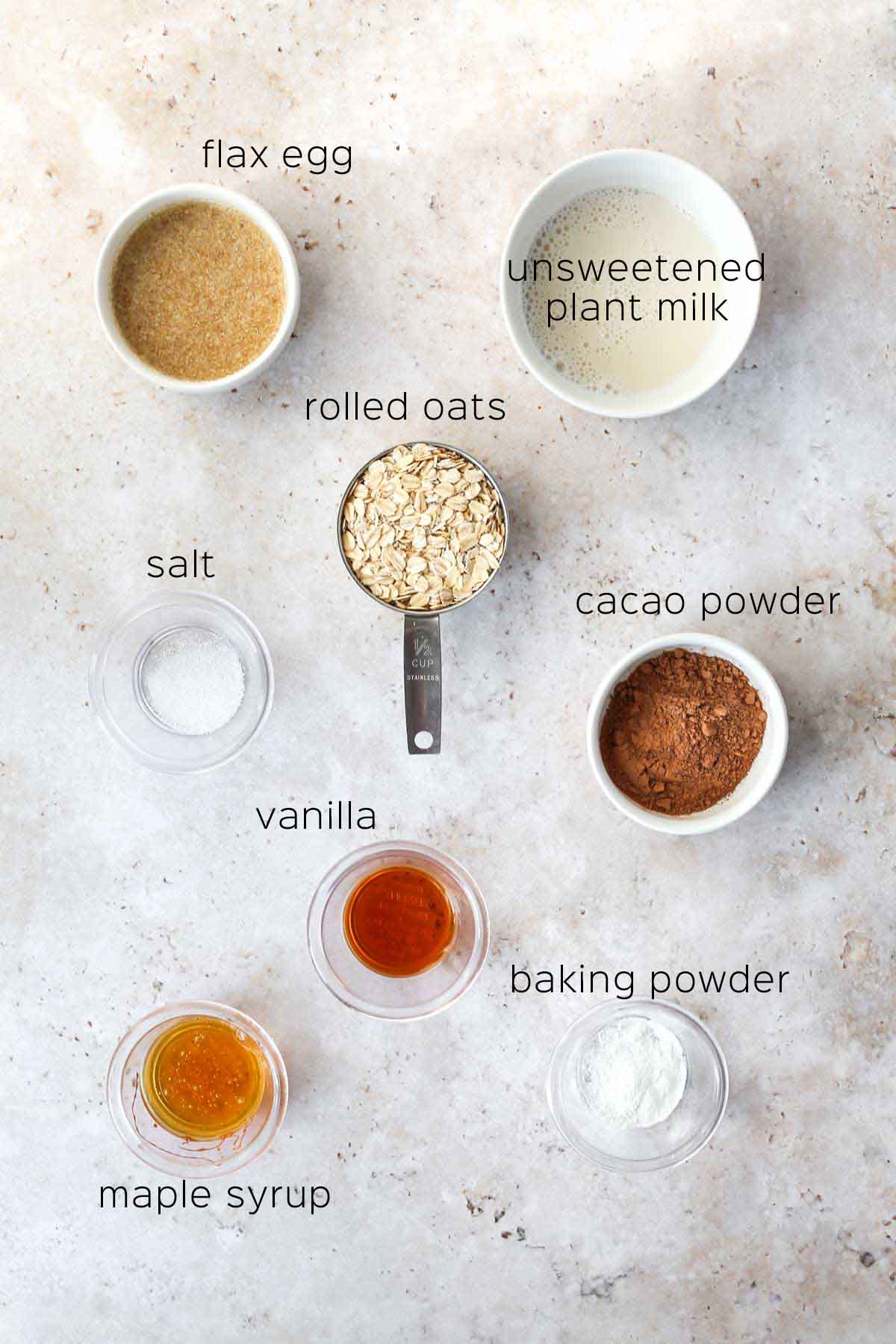 all of the ingredients to make the baked oats laid out on a table in small bowls and dishes.