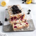 lemon bread with blackberries inside and on top.
