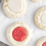 red and white thumbprint cookies with icing.